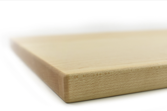 Close-up of a maple cutting board edge with a white background