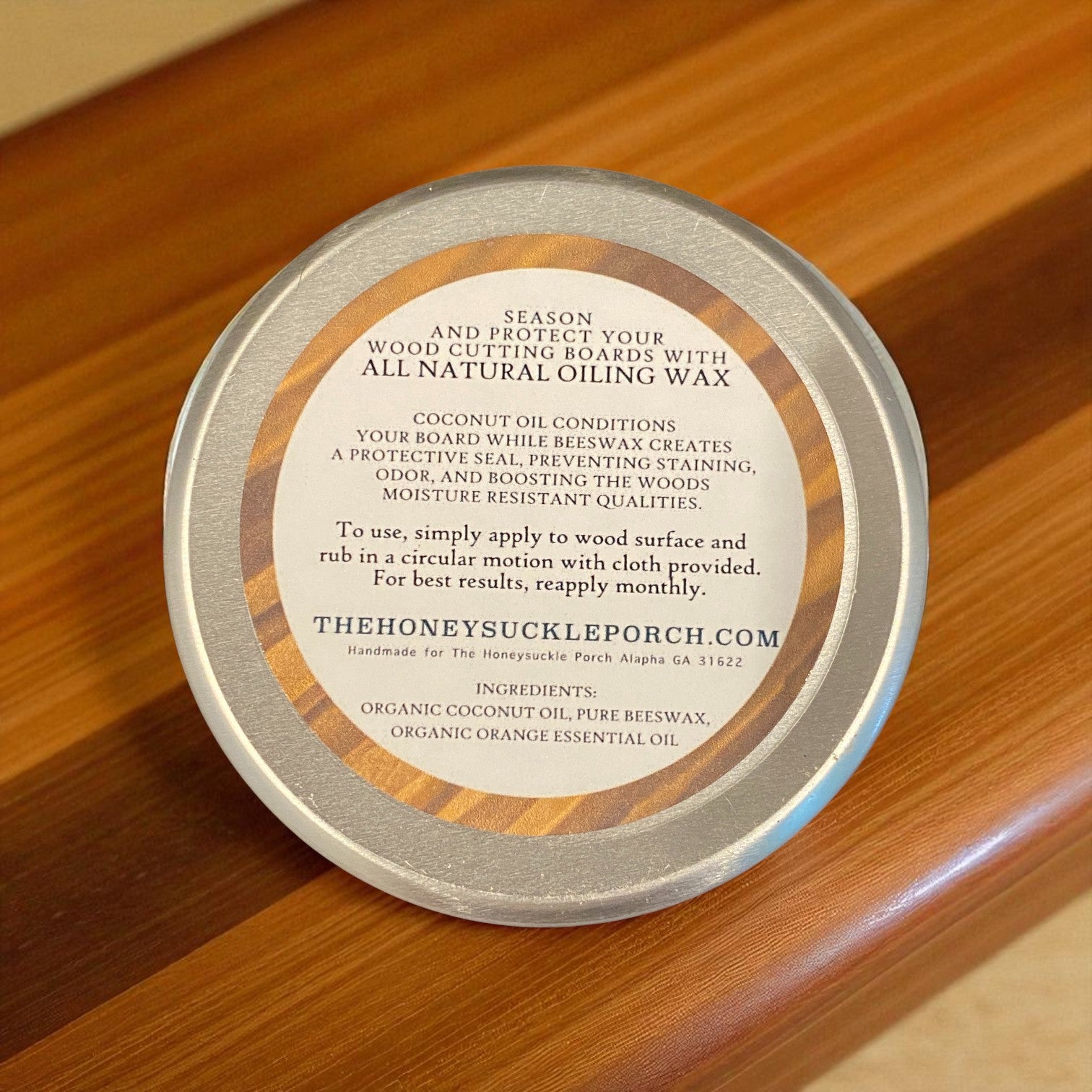 Tin of wood care product with label on a wooden surface