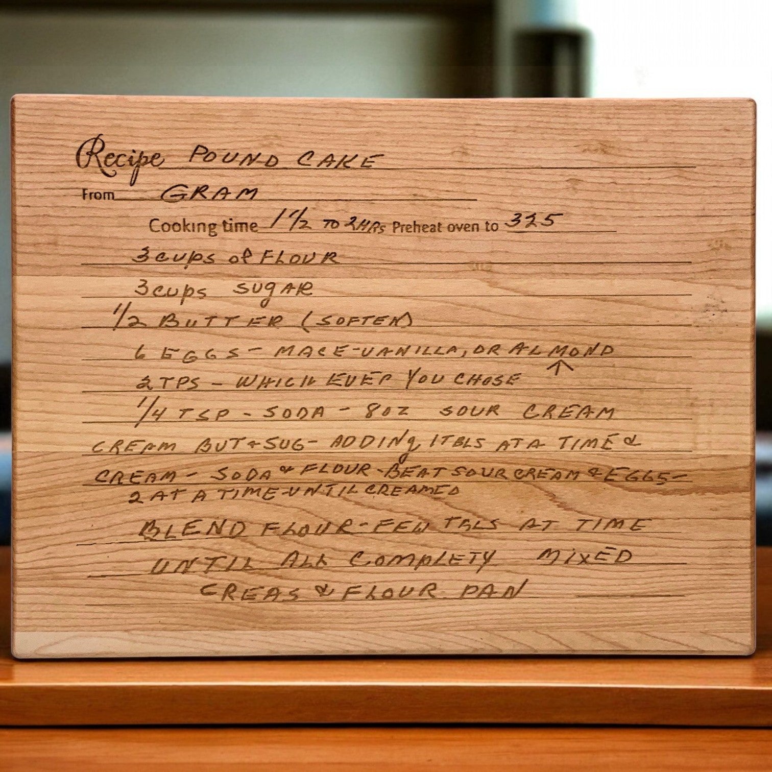 Wooden cutting board with handwritten cake recipe