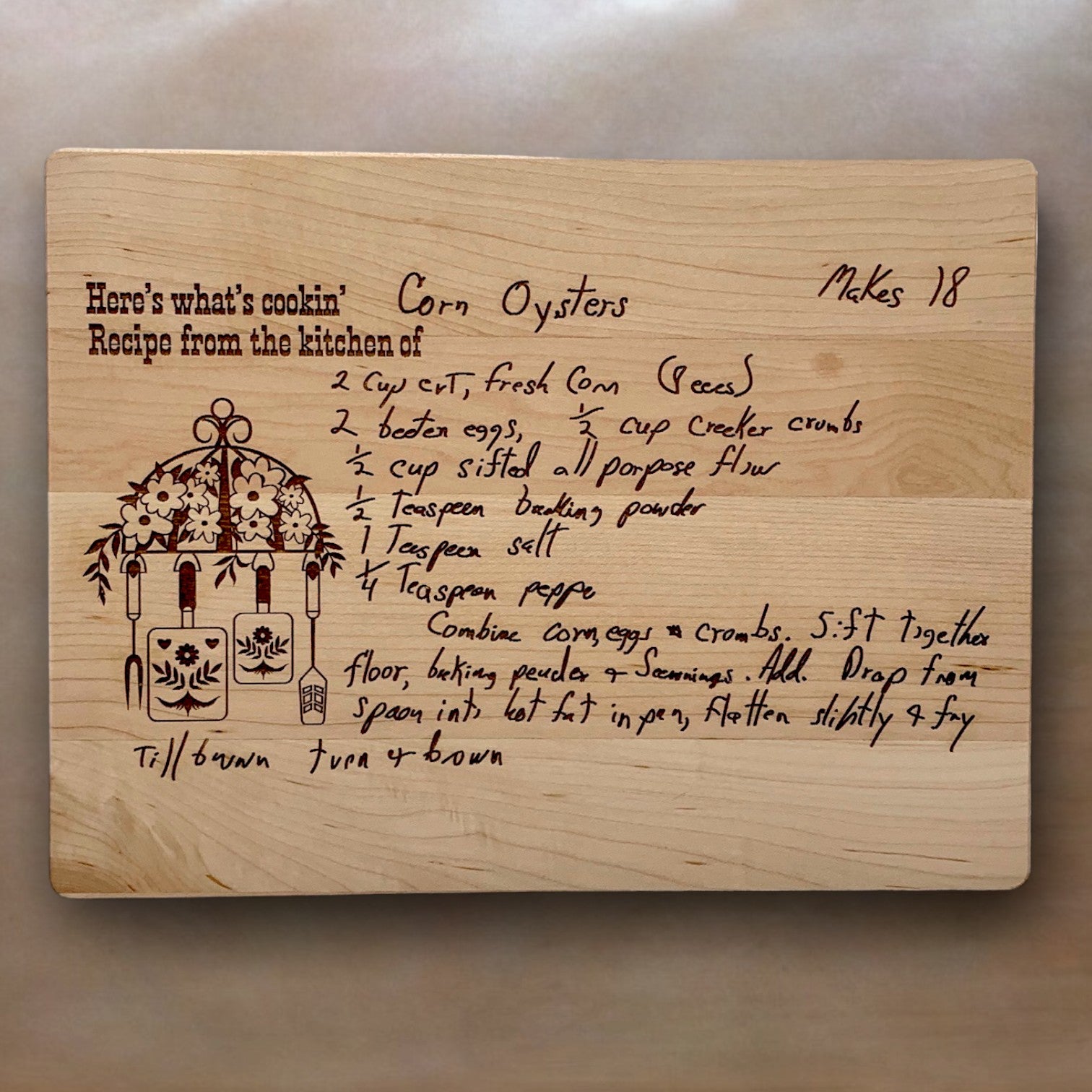 Wooden cutting board with handwritten engraved corn oysters recipe