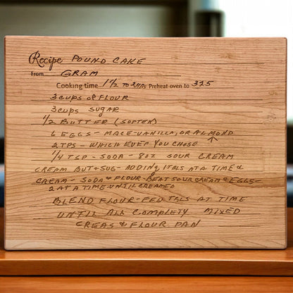 Wooden cutting board with handwritten cake recipe