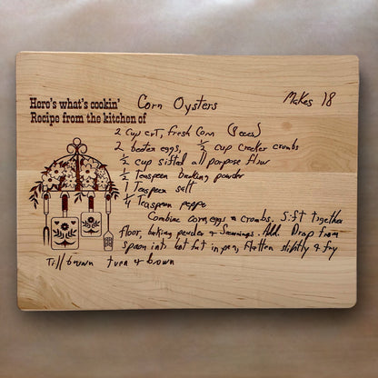 Wooden cutting board with handwritten engraved corn oysters recipe